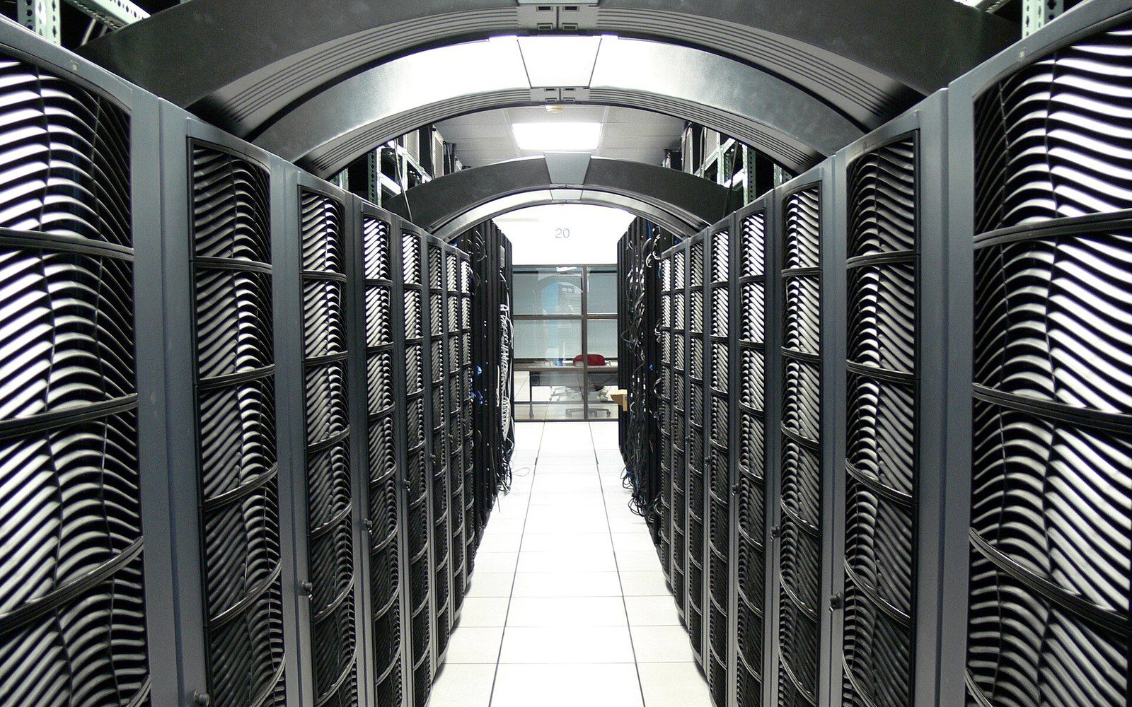 An aisle of compute racks in a machine room